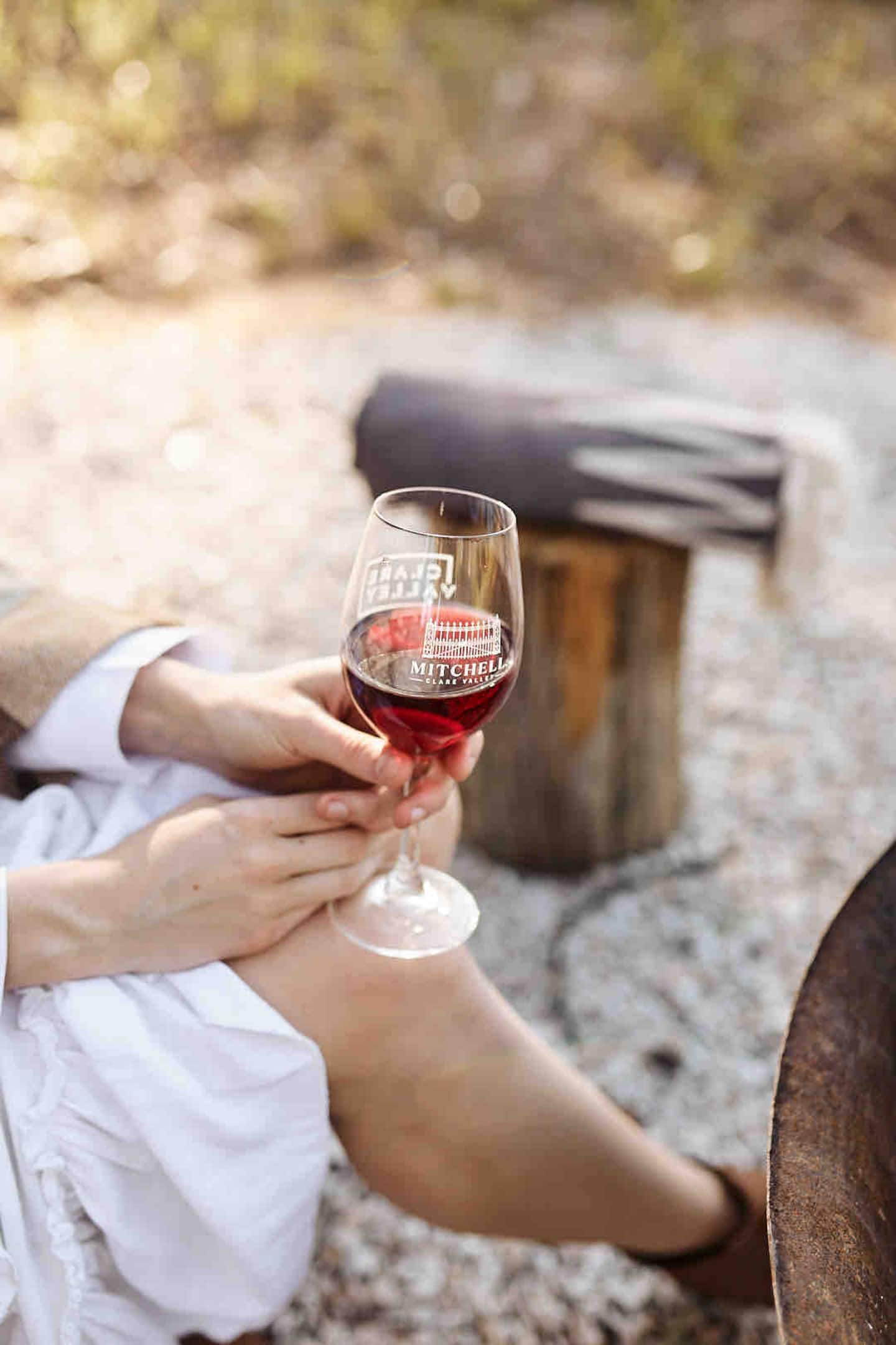 A guest enjoying a glass of red wine outdoors